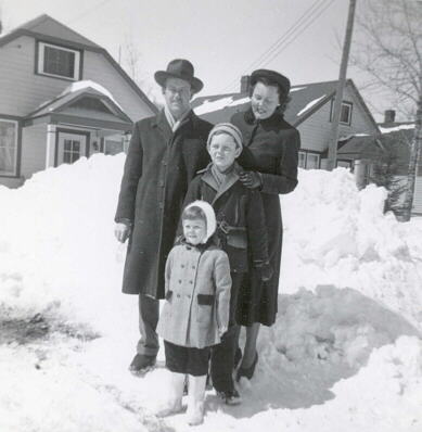 Dobie family standing in front of their house, Kearns Ont., 1949.